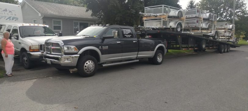 gooseneck trailer transporting heavy equipment across Canada and north america